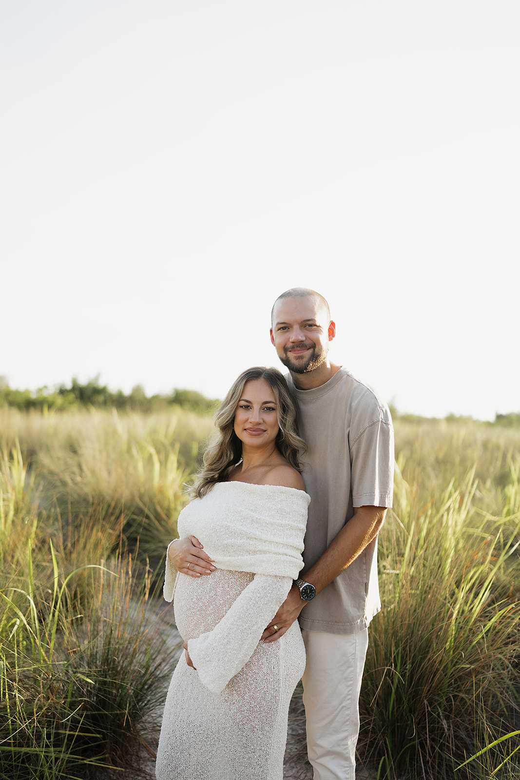 Beach maternity session with warm golden hour light